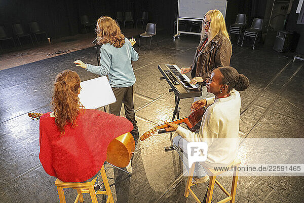 Persons with disabilities rehearsing music on stage