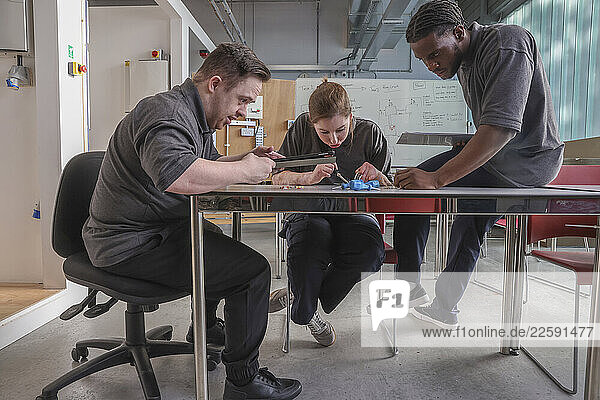 Disabled men and woman at workshop