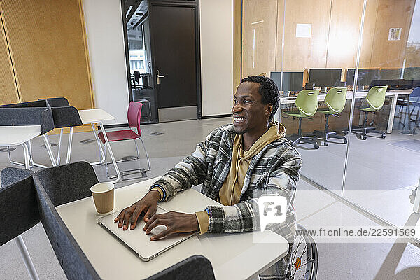 Man in wheelchair sitting in office