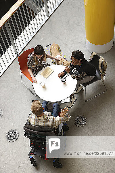 Disabled people talking at table