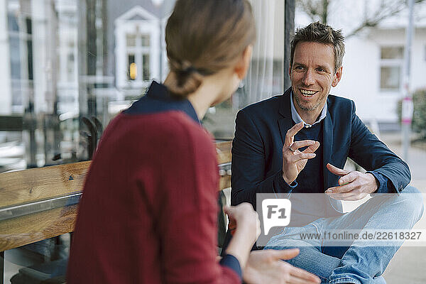 Two people having a business discussion at a café outdoors