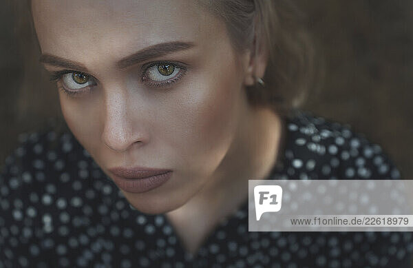 Serious woman with intense gaze looking at camera