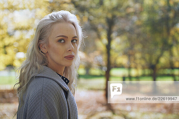 Blond woman in a park during autumn