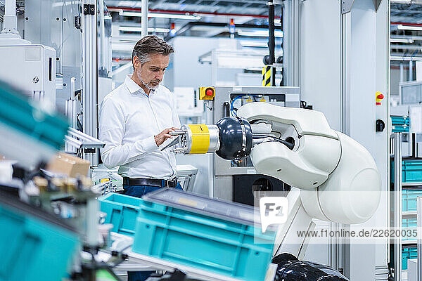 man in production hall  industry  business  industrial robot  portrait  tablet