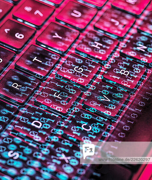 Close-up of a laptop keyboard with digital code overlay representing cybersecurity and cyber crime concepts