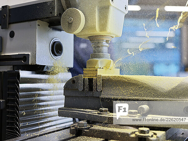 CNC machine cutting wood block at factory