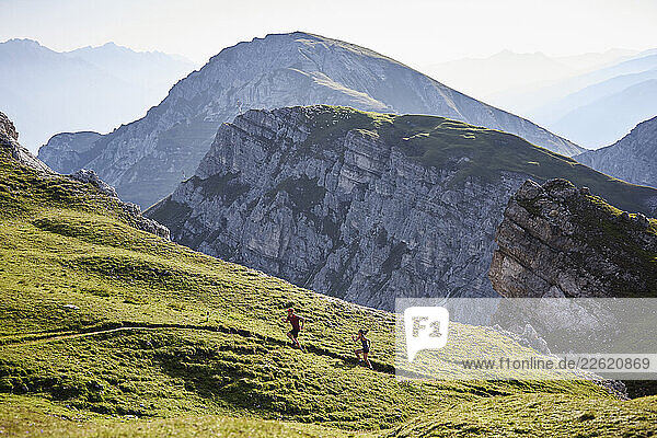 Man and woman running in the mountains