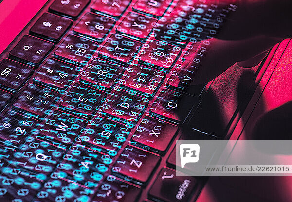 Hands typing on a laptop keyboard with digital overlay representing cybersecurity and cyber crime