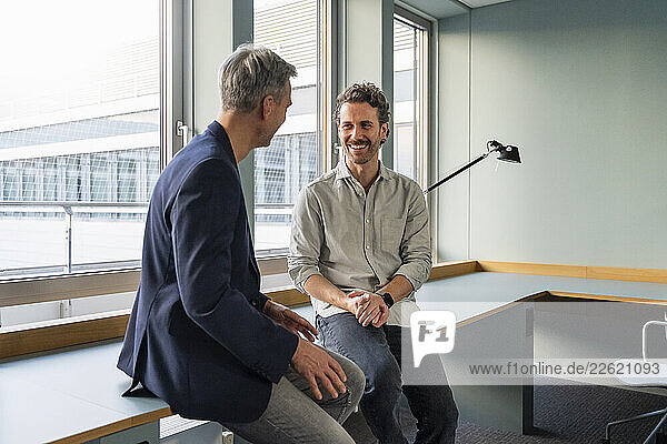 Two people having a business discussion in a modern office setting