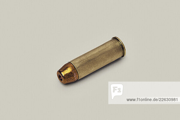 Still life of .44 Magnum bullet cartridge laying on white background