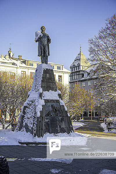 View of Brautryojandinn statue in Austurvollur park and gardens on a sunny day in winter  Reykjavik  Iceland