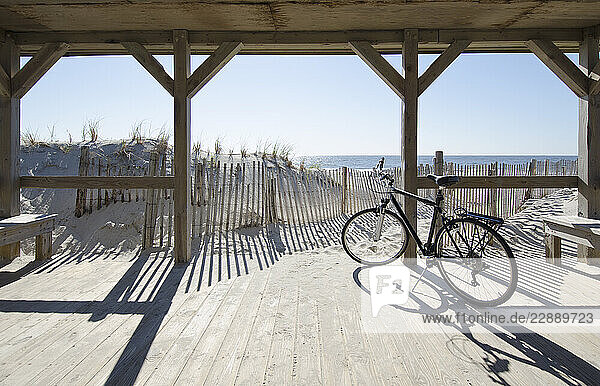 Bicycle by path to beach on sunny day