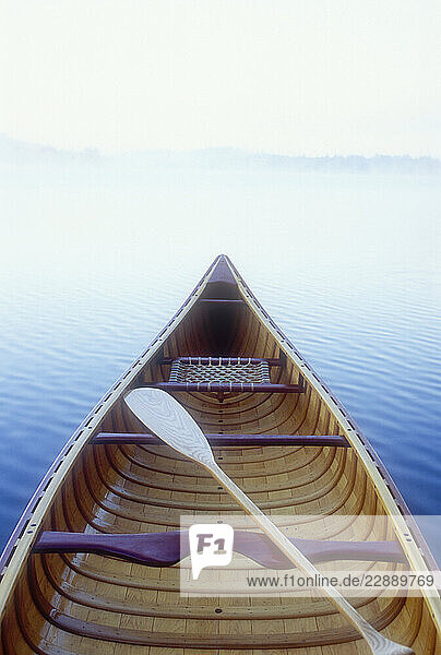 Wood canoe in morning mist on Saranac Lake