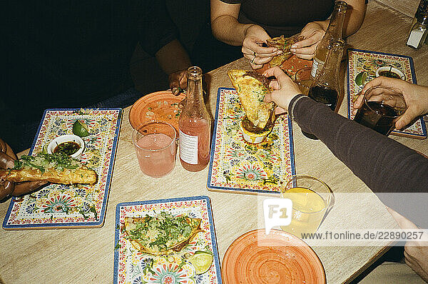 High angle view of friends enjoying fast food at restaurant