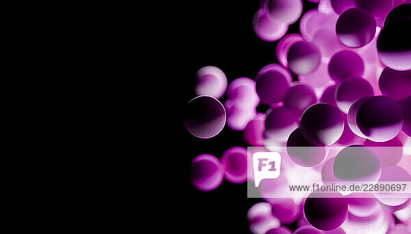 Glowing pink spheres cluster against a dark black background  creating a surreal abstract pattern. Blender 3D illustration