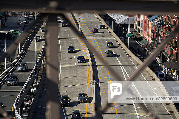 Elevated view of cars on a highway with industrial buildings on the right. New York City  USA