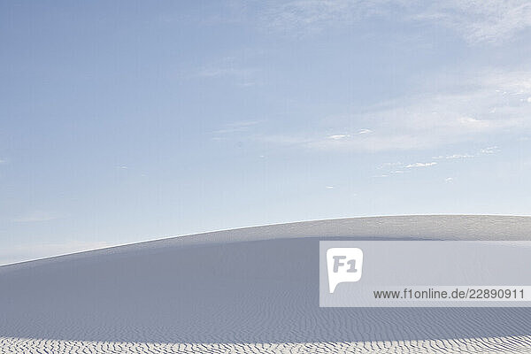 Vast  serene white sand dune under a clear  expansive blue sky. Road Trip USA