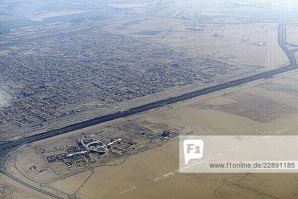 Aerial view of urban and desert landscapes showing a distinct boundary between developed and arid land. Abu Dhabi  UAE