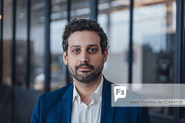 Confident engineer in business attire looking at camera indoors