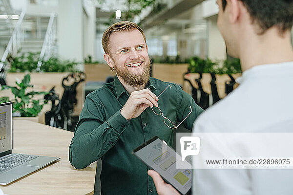 Business colleagues discussing in a modern office setting