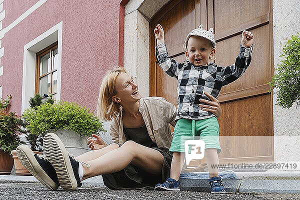 Mother and son enjoying leisure time outdoors on a street