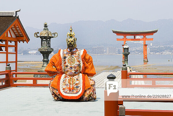 Dance ceremony Bugaku on a stage of the Itsukushima-jinja Shrine on the Miyajima Island  off Hiroshima  Japan