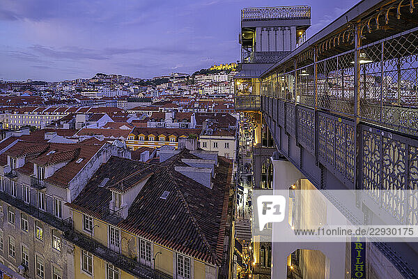 View of city rooftops and Santa Justa Lift from Carmo Archaeological Museum at dusk  Lisbon  Portugal  Europe