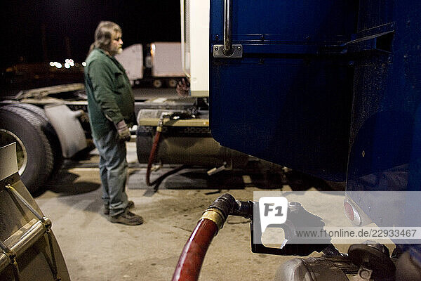A trucker fills up on diesel in Bangor  Maine.