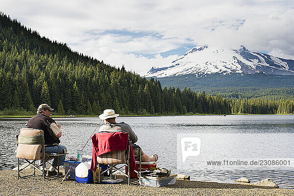 Two older grown men fishing from shore of Trillium Lake