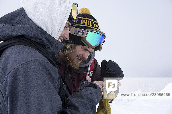 Snowboarder determining lines by looking at phone