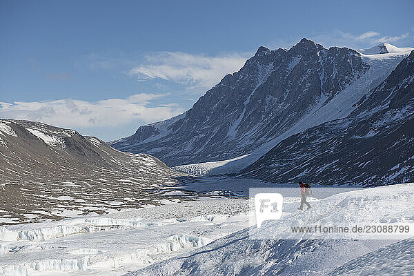 A scientist walks across the Canada Glacier in the Taylor Valley Antarctica.