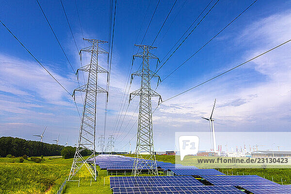 Netherlands  Zeeland  photovoltaic panel fields  with electricity pylons and wind turbines